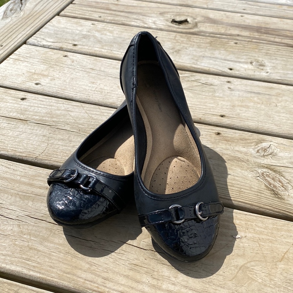 Black flats with shiny silver buckles